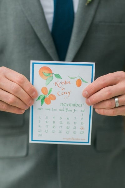 Groom holding invitation